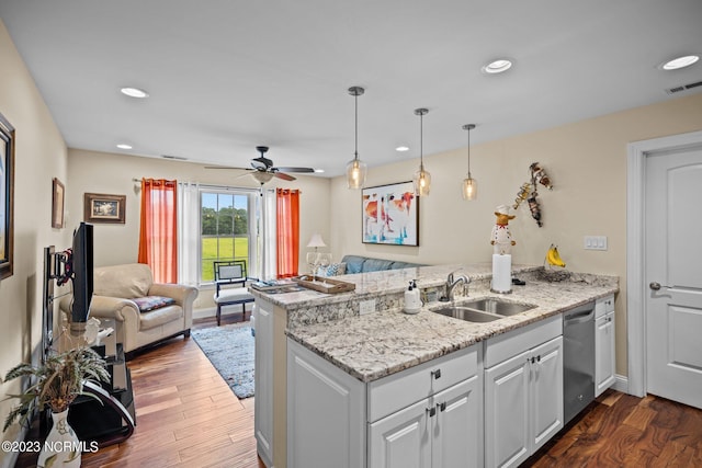 kitchen with white cabinetry, dark hardwood / wood-style flooring, stainless steel dishwasher, and kitchen peninsula