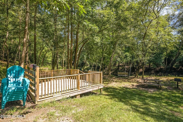 view of yard with a playground and a deck