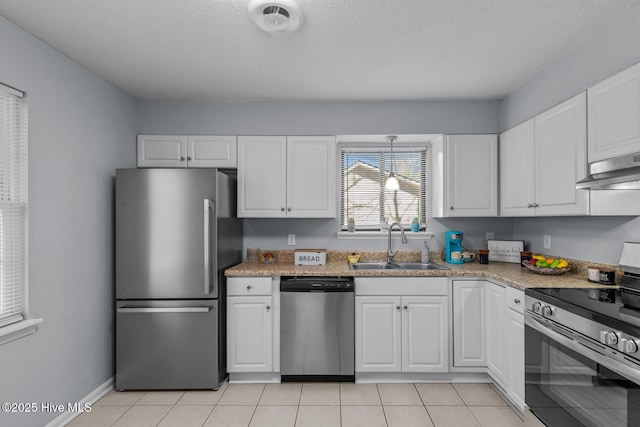 kitchen featuring white cabinetry, sink, stainless steel appliances, and light tile patterned flooring