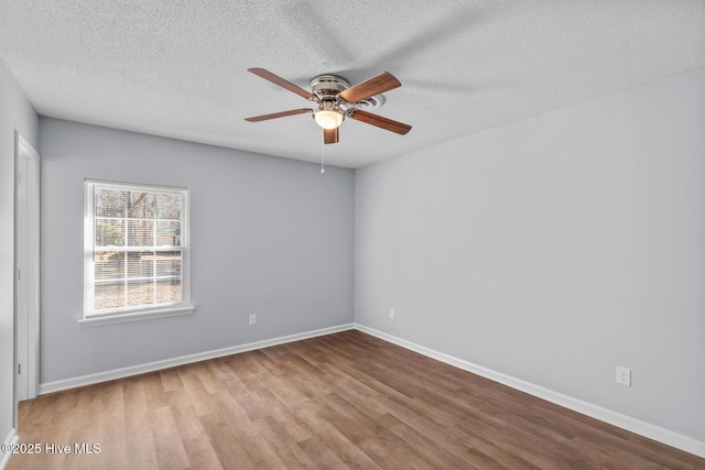 unfurnished room with ceiling fan, light hardwood / wood-style flooring, and a textured ceiling