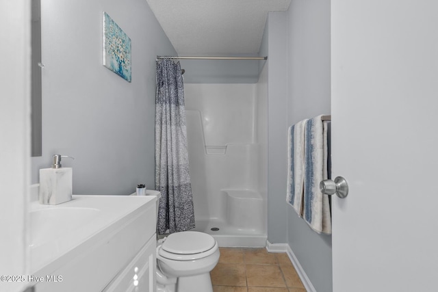 bathroom featuring curtained shower, tile patterned flooring, vanity, toilet, and a textured ceiling