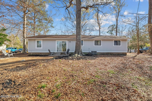 back of house with central AC unit