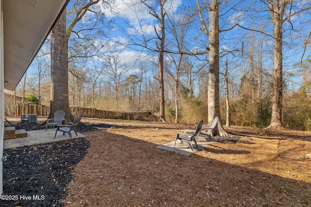 view of yard with central AC and a patio area