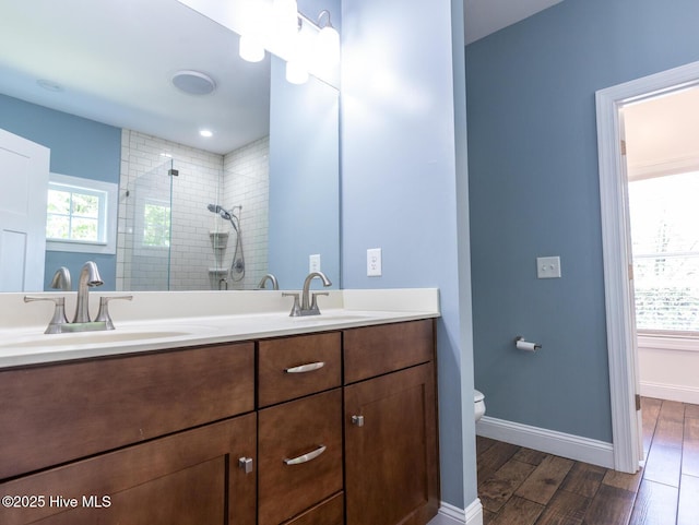 214 Admiral Ct, Sneads Ferry, NC 28460 - bathroom with double vanity, tiled shower, and wood finished floors