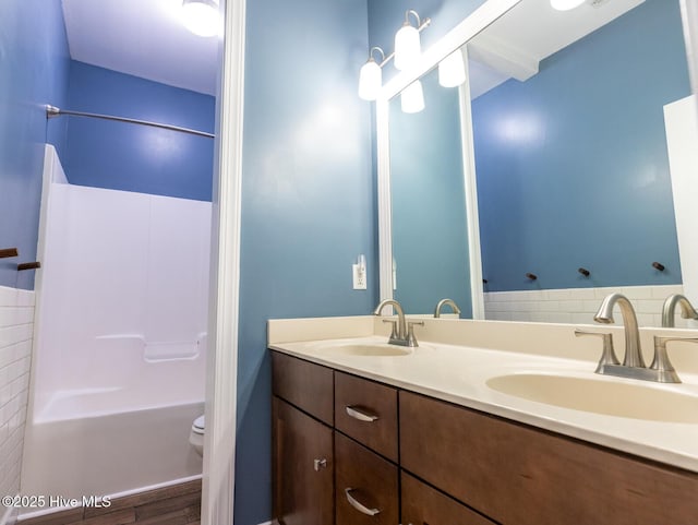 214 Admiral Ct, Sneads Ferry, NC 28460 - bathroom featuring double vanity, wood finished floors, and bathtub / shower combination