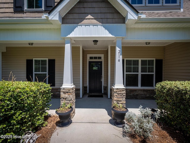 214 Admiral Ct, Sneads Ferry, NC 28460 - doorway to property featuring a porch and stone siding