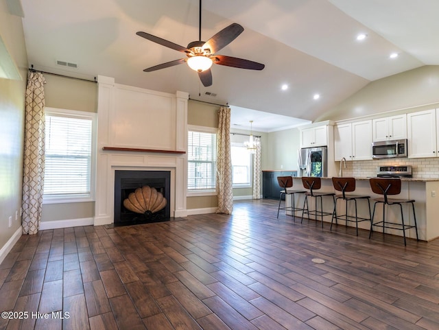 214 Admiral Ct, Sneads Ferry, NC 28460 - kitchen with appliances with stainless steel finishes, white cabinets, a kitchen breakfast bar, ceiling fan, and vaulted ceiling