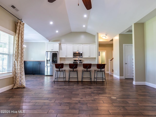 214 Admiral Ct, Sneads Ferry, NC 28460 - kitchen with stainless steel appliances, ceiling fan, white cabinetry, a kitchen breakfast bar, and an island with sink