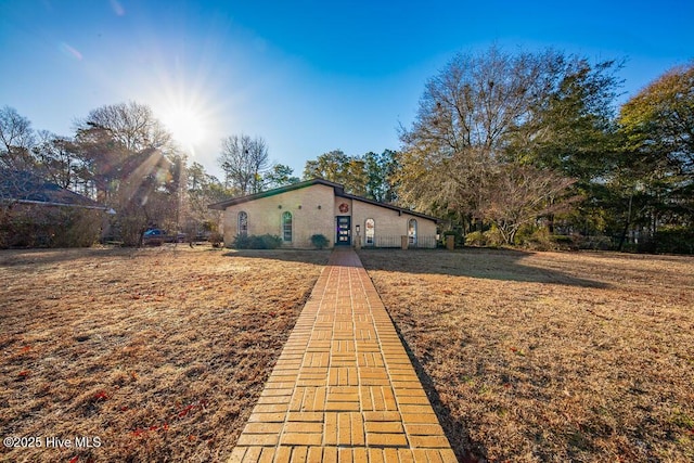 view of property exterior with a yard