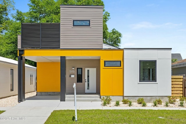 contemporary home featuring a carport