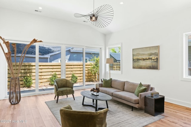 living room with lofted ceiling and hardwood / wood-style floors