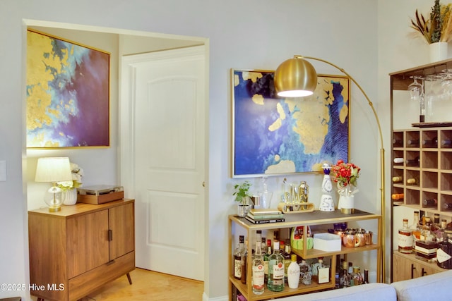 bar featuring light hardwood / wood-style flooring