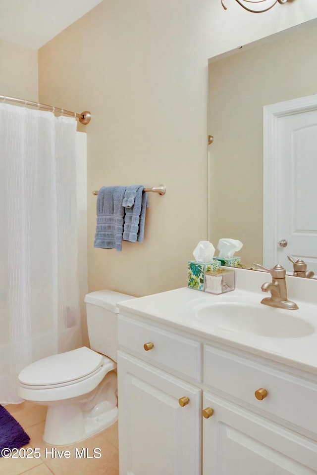 bathroom with a shower with curtain, vanity, tile patterned floors, and toilet