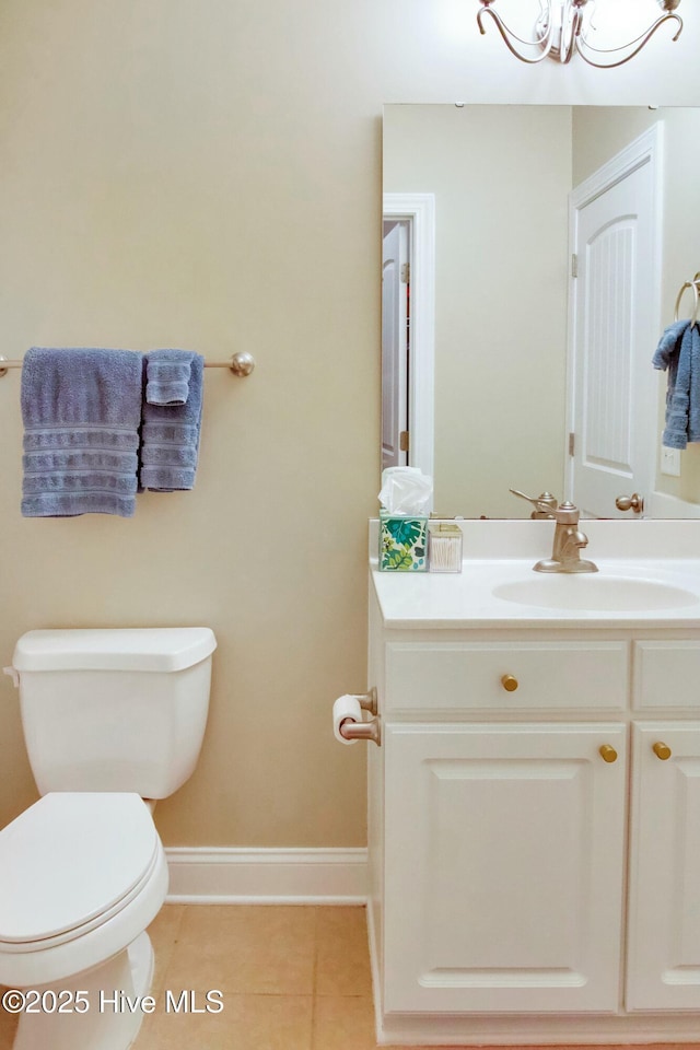 bathroom with tile patterned flooring, vanity, and toilet