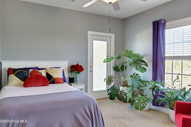 carpeted bedroom with multiple windows and ceiling fan