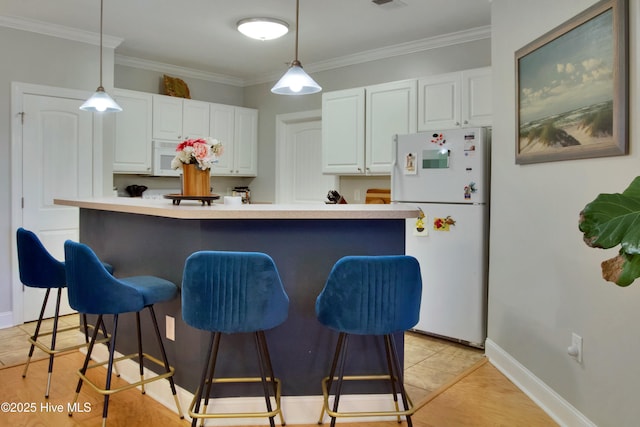 kitchen with ornamental molding, pendant lighting, white cabinets, and white appliances