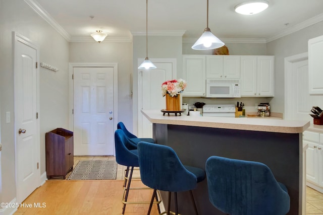 kitchen with white cabinetry, stove, pendant lighting, and crown molding