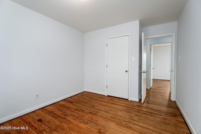 unfurnished bedroom featuring hardwood / wood-style flooring