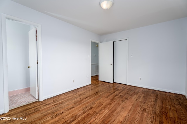 unfurnished bedroom with wood-type flooring