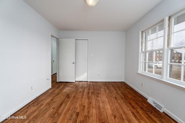 spare room with dark wood-type flooring