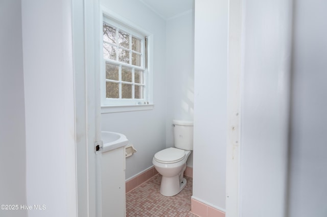 bathroom featuring tile patterned flooring, vanity, and toilet