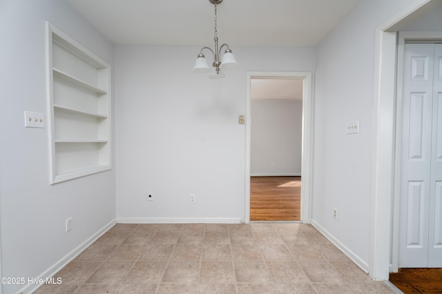 unfurnished dining area with built in features and a chandelier