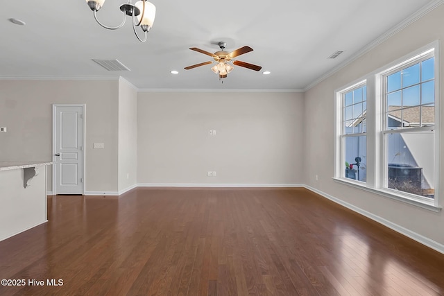 spare room with crown molding, dark hardwood / wood-style floors, and ceiling fan with notable chandelier