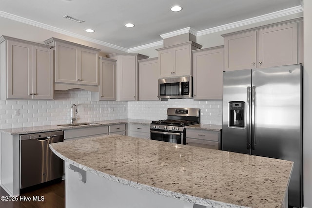 kitchen with ornamental molding, appliances with stainless steel finishes, sink, and decorative backsplash