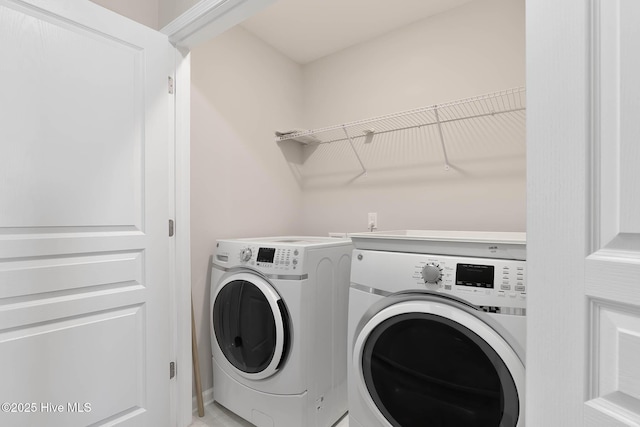 clothes washing area featuring washer and clothes dryer