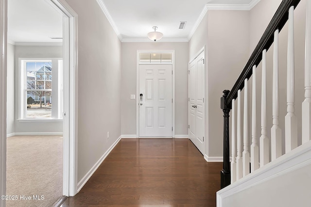 foyer with ornamental molding and dark hardwood / wood-style flooring