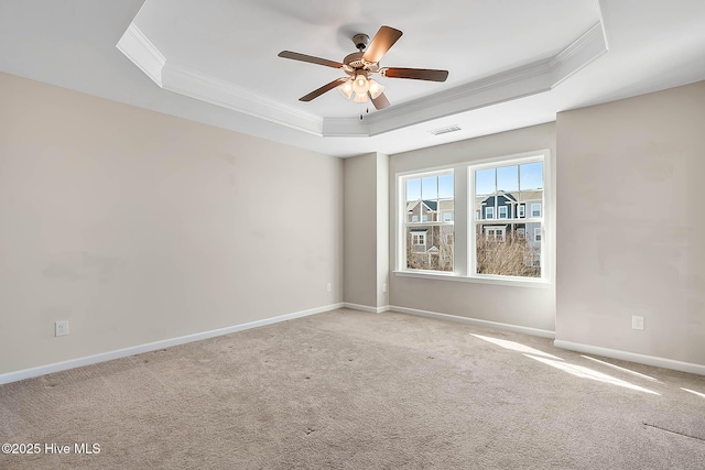 carpeted empty room featuring ornamental molding, a raised ceiling, and ceiling fan