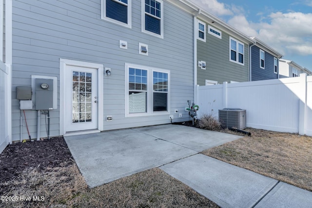 rear view of house featuring cooling unit and a patio