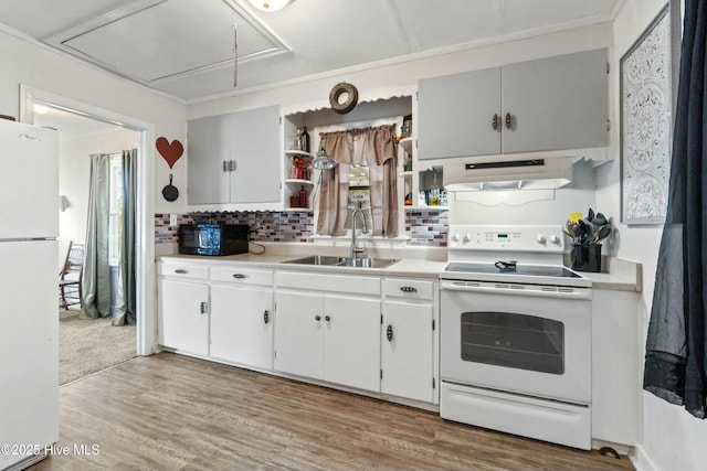 kitchen featuring hardwood / wood-style flooring, white cabinetry, sink, and white appliances