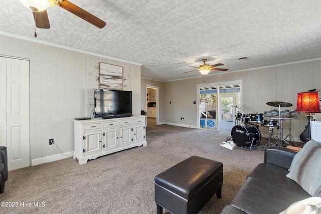 carpeted living room featuring crown molding and ceiling fan