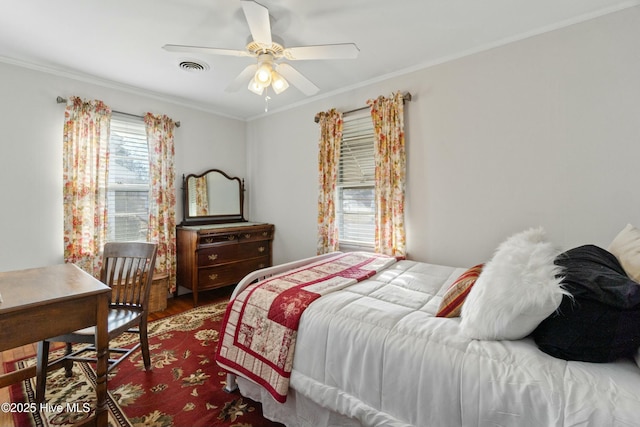 bedroom featuring crown molding, hardwood / wood-style flooring, and ceiling fan