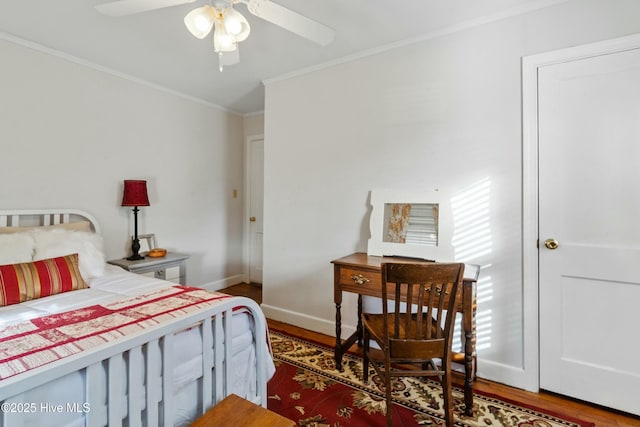 bedroom featuring crown molding, dark wood-type flooring, and ceiling fan