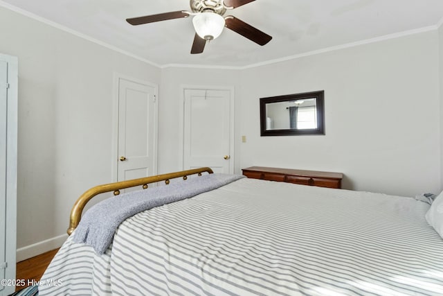 bedroom with crown molding, ceiling fan, hardwood / wood-style floors, and a closet