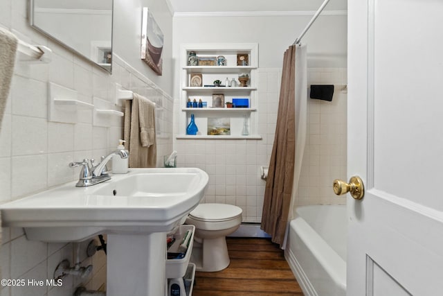 bathroom featuring shower / bath combination with curtain, ornamental molding, wood-type flooring, and tile walls