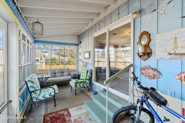 sunroom featuring vaulted ceiling with beams