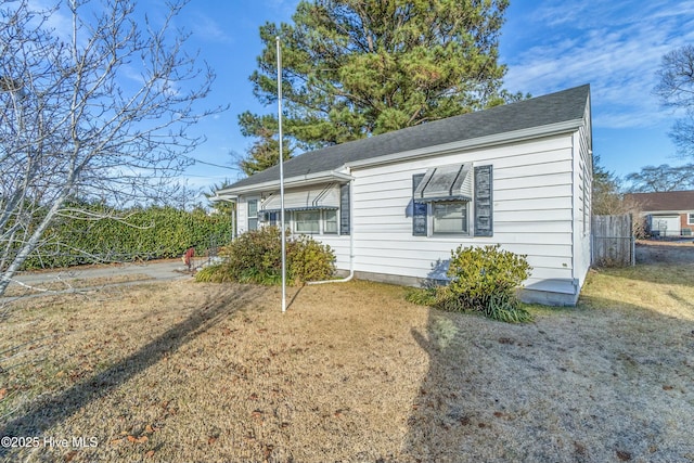 view of side of property with a lawn