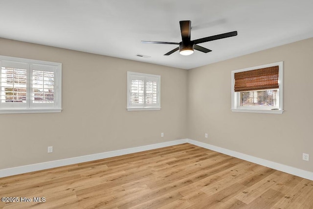 spare room with plenty of natural light, light hardwood / wood-style floors, and ceiling fan