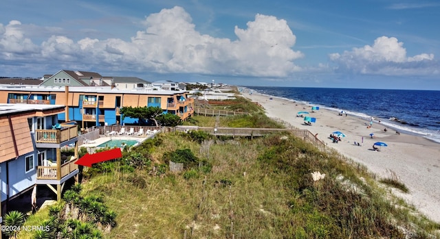 birds eye view of property featuring a beach view and a water view