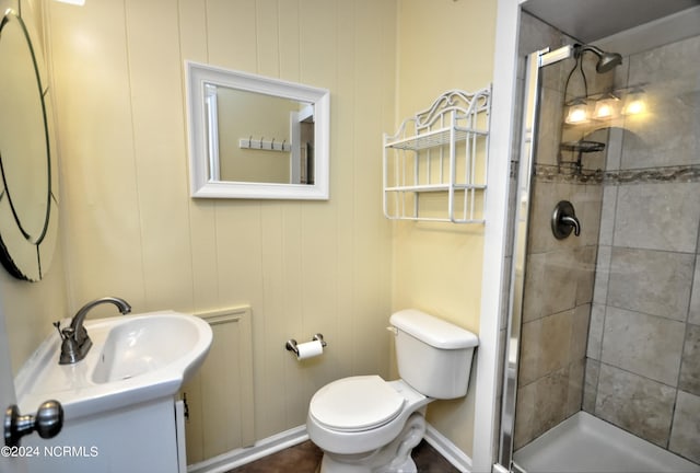 bathroom with walk in shower, vanity, and toilet