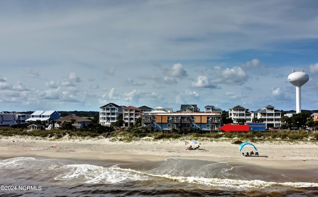 surrounding community with a view of the beach and a water view