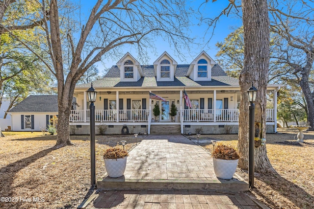 cape cod house featuring a porch