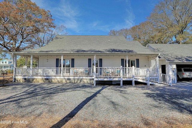 rear view of property featuring a porch, roof with shingles, and crawl space