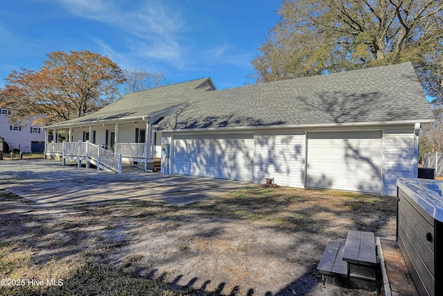 view of front of home with a porch, driveway, and a shingled roof