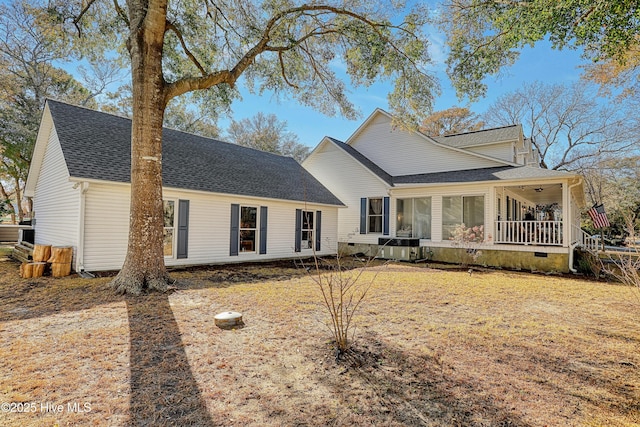 view of front of home featuring a front yard, roof with shingles, and crawl space