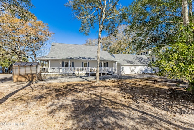 back of house featuring an outdoor structure and an exterior structure