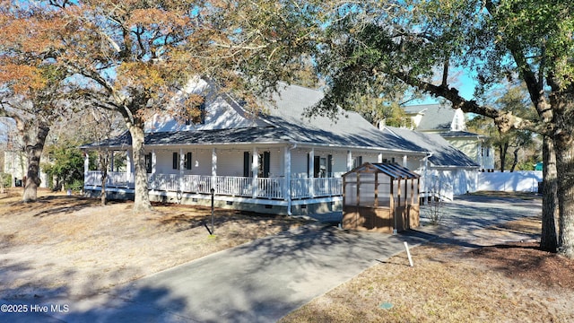 farmhouse inspired home featuring an outbuilding, a porch, fence, an exterior structure, and crawl space